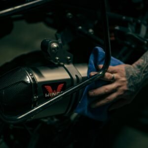 a close up of a person's hand on a motorcycle