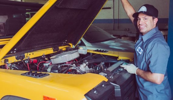 man holding open-wide car trunk